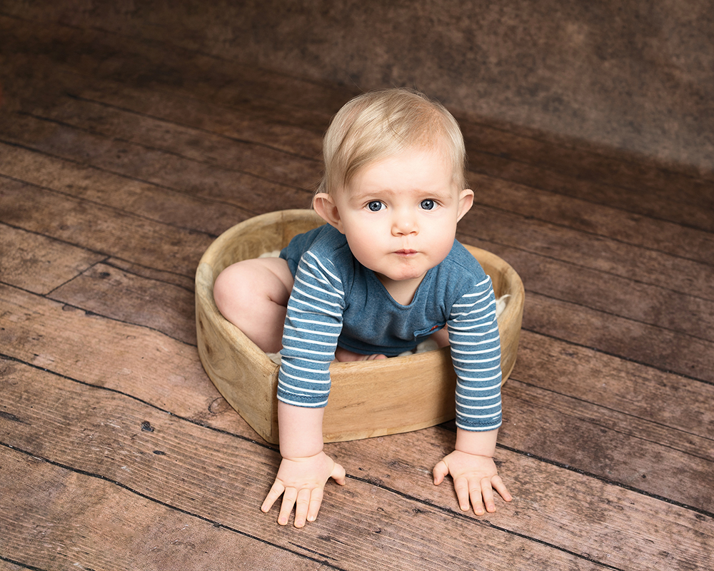 Baby boy sat in a heart shaped bowl taken by Alice James Photography, baby photographer Hitchin