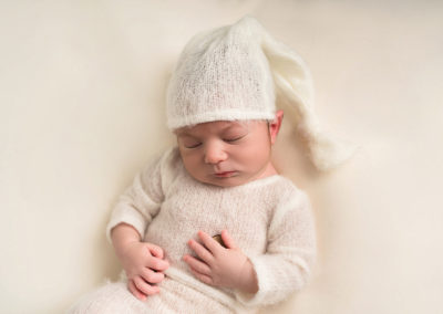 Baby boy in cream taken by Alice James Photography, newborn photographer Hertfordshire