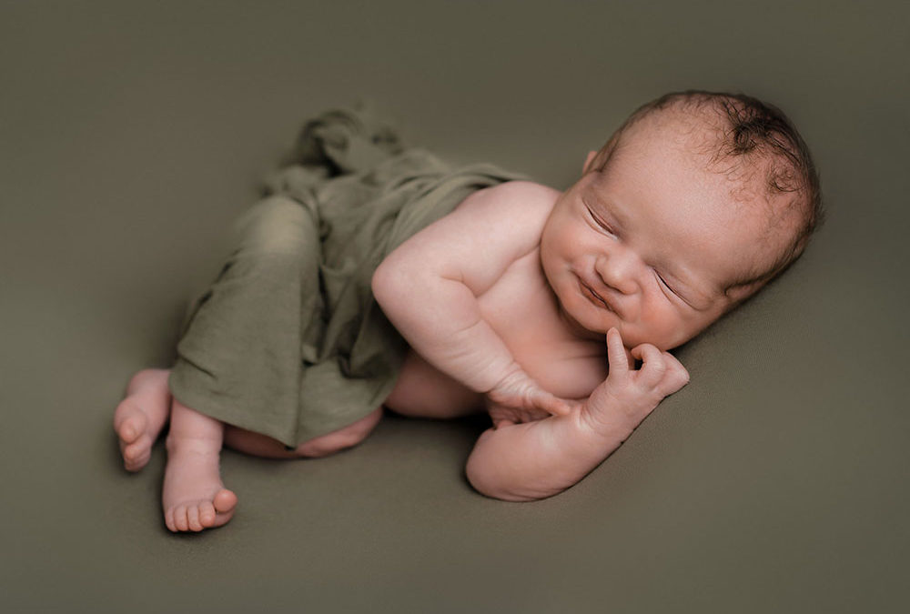 Baby boy asleep on green blanket taken by Alice James Photography, Stotfold Newborn Photographer