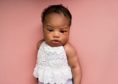 Baby girl wearing lace vest taken by ALcier James Photography, newborn photographer Hertfordshire