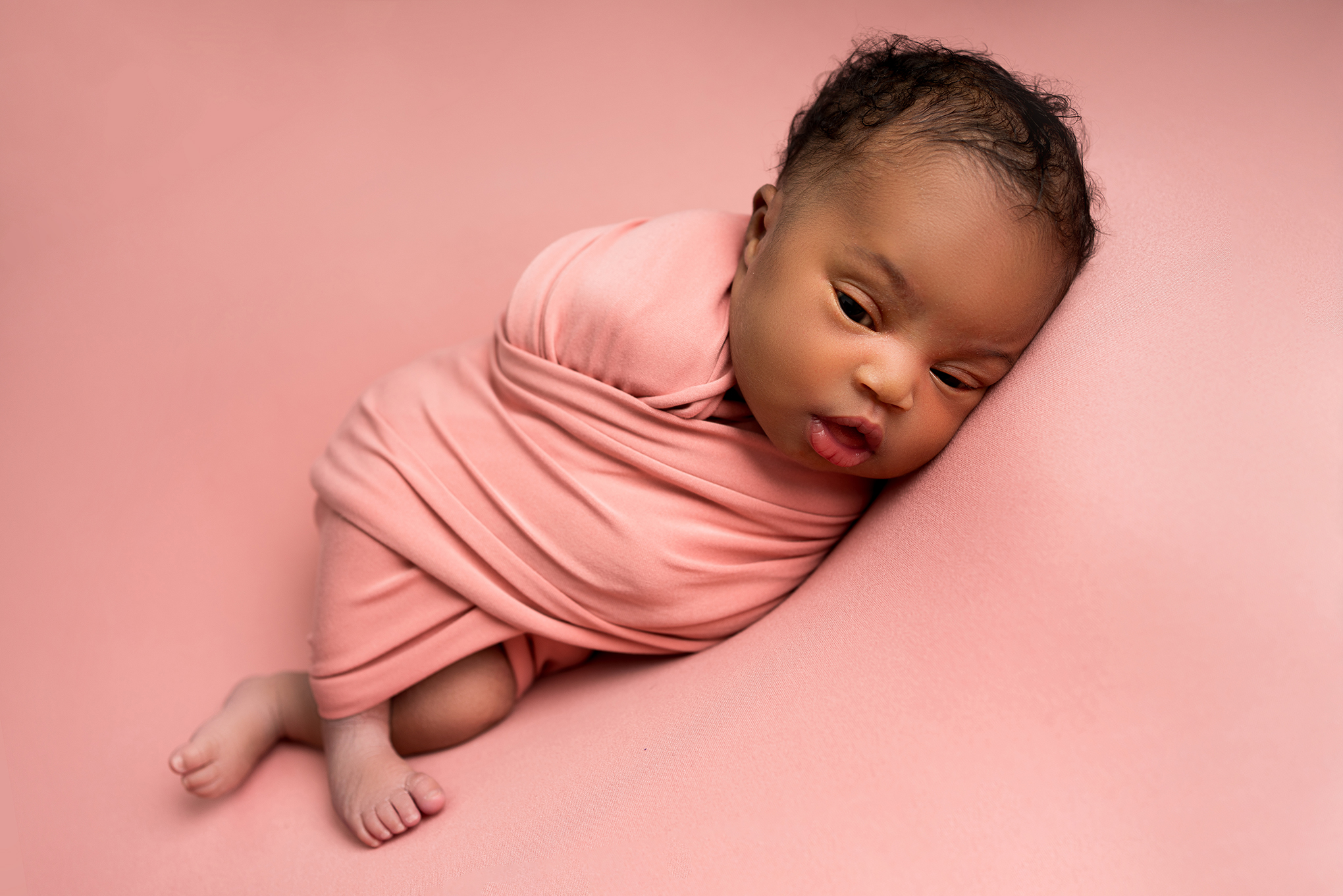 Newborn baby girl wrapped in Pink taken by Alice James Photography, in a newborn photoshoot, Hitchin