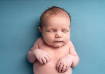 Baby boy asleep on a blue blanket taken by Alice James Photography, newborn Photographer Hertfordshire