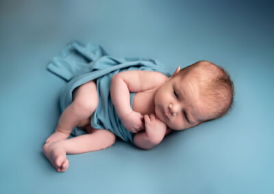 Baby boy wrapped in blue Alice James Photography, newborn Photographer Hertfordshire